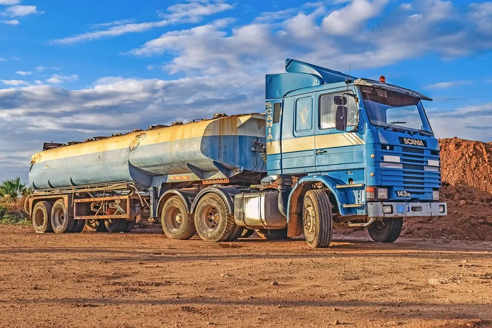 Petroleum tanker truck parked on a red earth site
