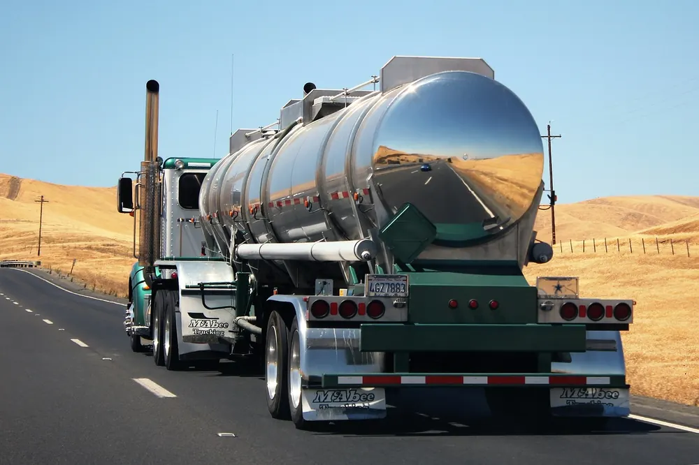Chrome tanker truck carrying bulk fuel on a highway